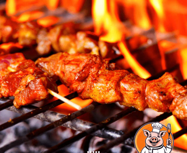 Pork skewers grilled over an open flame.