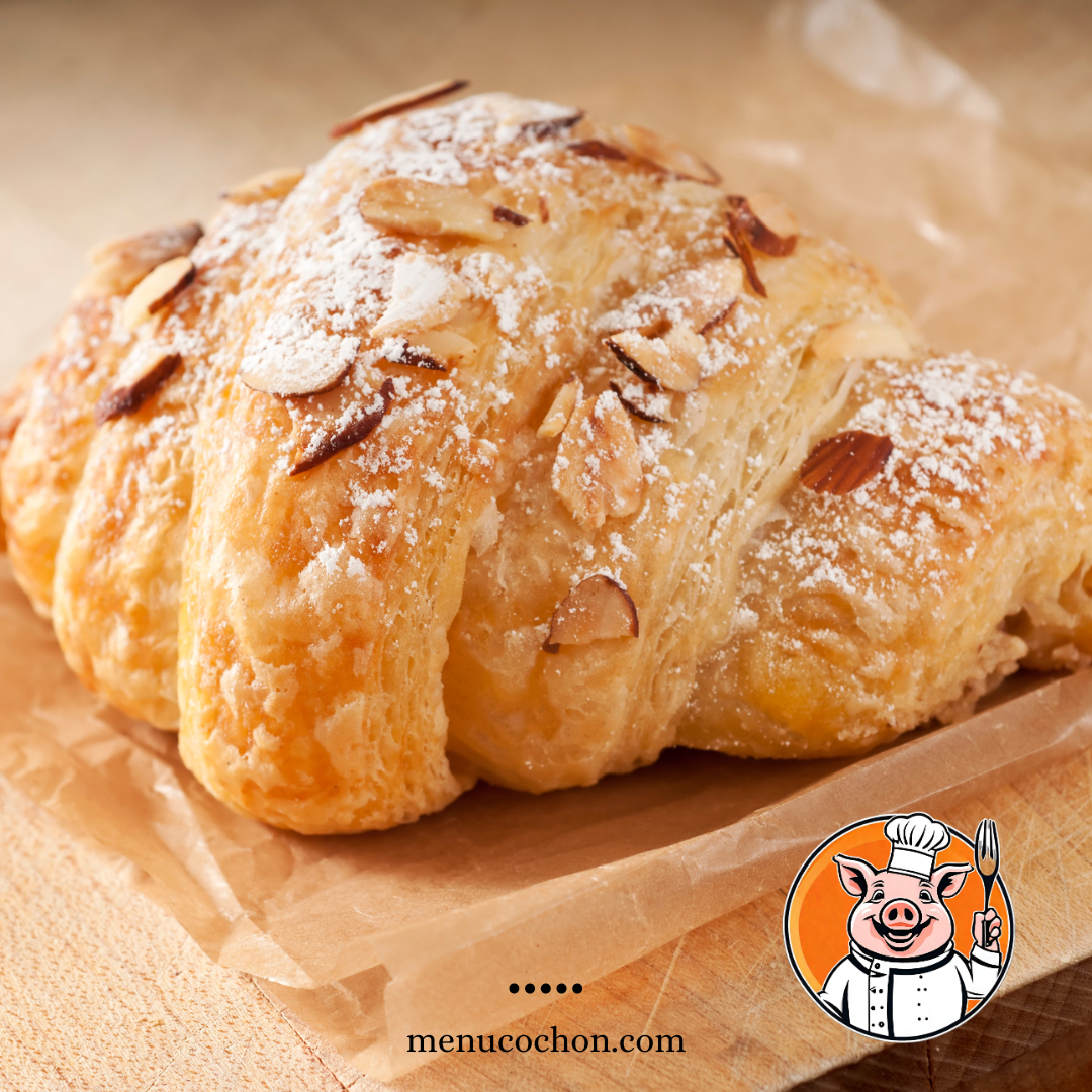 Almond croissant on wooden table.