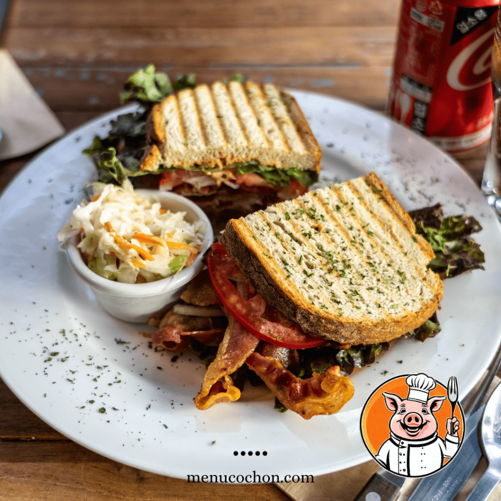 BLT sandwich with French fries and cola.