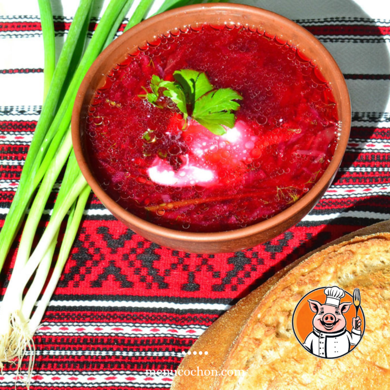 Traditional borscht, green onions, bread on ethnic tablecloth.
