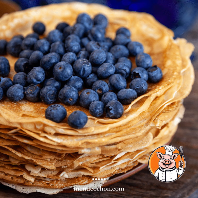 Stacked thin pancakes with fresh blueberries.
