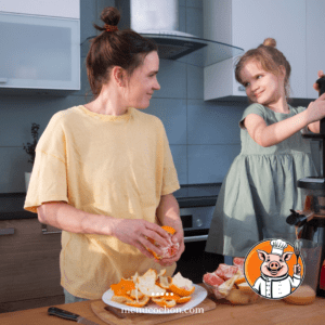 Mother and daughter making homemade orange juice.