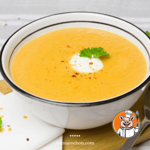 Creamy squash soup topped with cream.