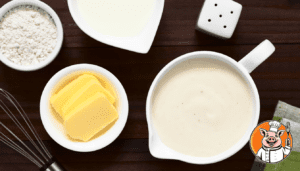 Ingredients for béchamel sauce on wooden table.