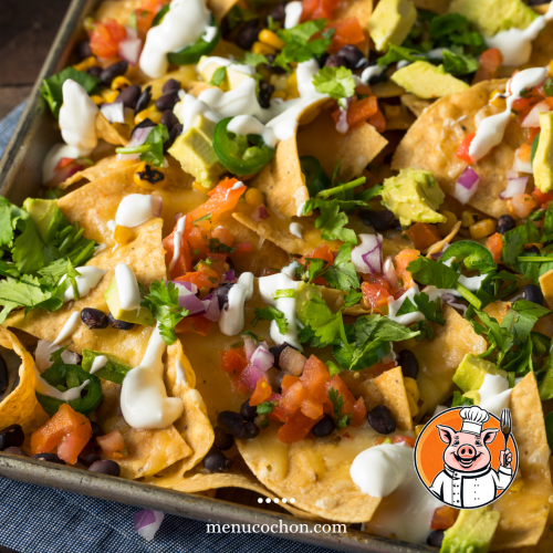 Nachos topped with cheese and fresh vegetables.